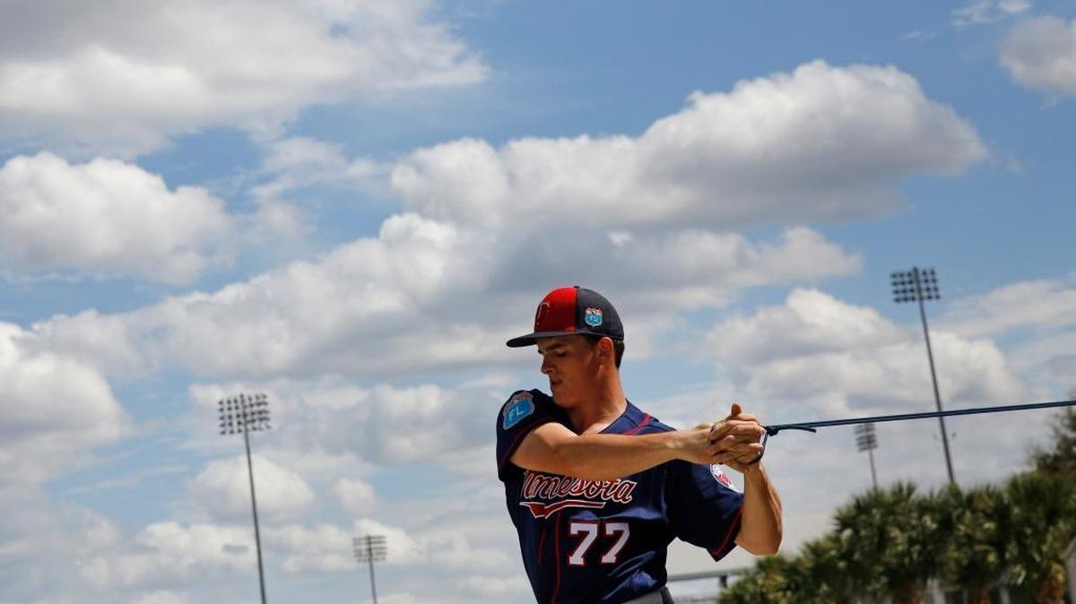 Minnesota Twins pitcher Nick Burdi stretched with an elastic band during a spring training workout in Fort Myers, Fla., on Feb. 29.