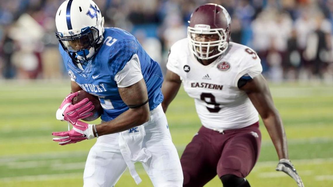 Kentucky Wildcats wide receiver Dorian Baker (2) scored the winning td on a pass from Kentucky Wildcats quarterback Patrick Towles (14) as Eastern Kentucky Colonels defensive lineman Noah Spence (9) defended as the University of Kentucky played Eastern Kentucky University in Commonwealth Stadium in Lexington, Ky., Saturday, October 03, 2015. This is in overtime college football action. UK won 34-27 in overtime.