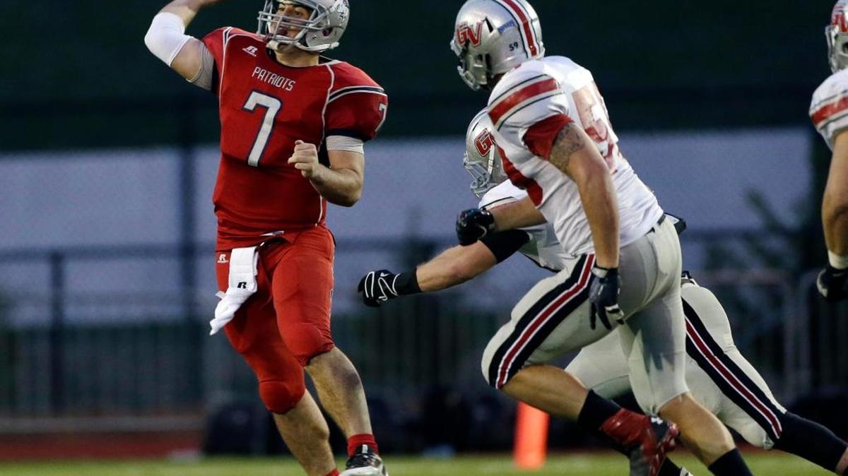Cumberlands quarterback Adam Craig throws under pressure from Grand View’s Blake Goodenbour (59) during the first half of the NAIA college football championship game Saturday, Dec. 21, 2013, in Rome, Ga. Grand View won 35-23.