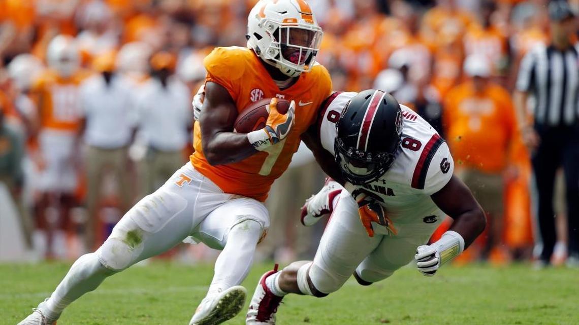 Tennessee running back John Kelly (4) runs for yardage as he's hit by South Carolina defensive lineman D.J. Wonnum (8) in the first half of an NCAA college football game Saturday, Oct. 14, 2017, in Knoxville, Tenn.