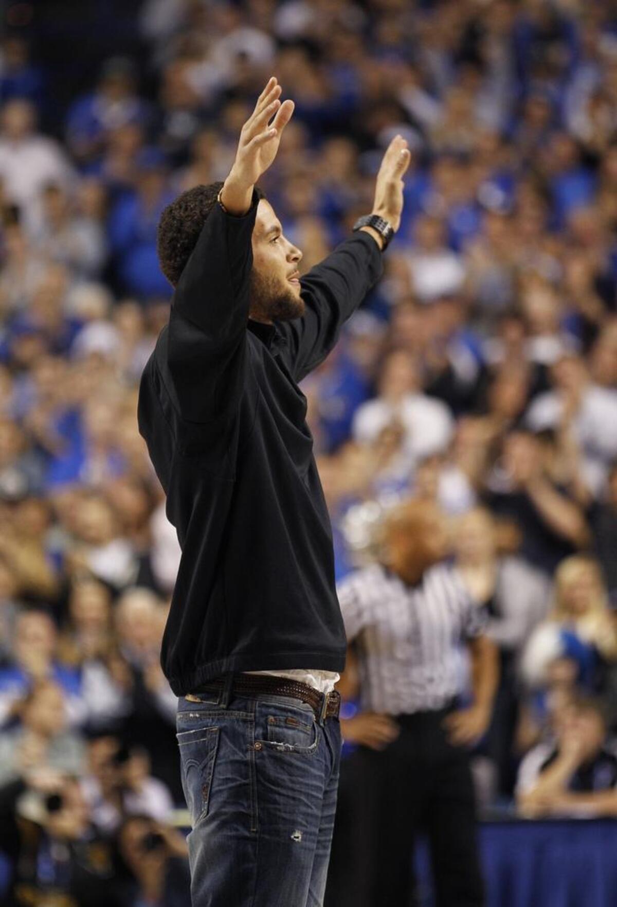UK football hero Matt Roark performed the “Y” in the Kentucky cheer as the basketball team played Portland in Rupp Arena on Nov. 26, 2011.