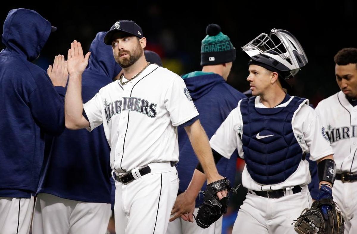 The Seattle Mariners’ Tony Zych and Tuffy Gosewisch shared congratulations with teammates after a win against the A’s on May 15.