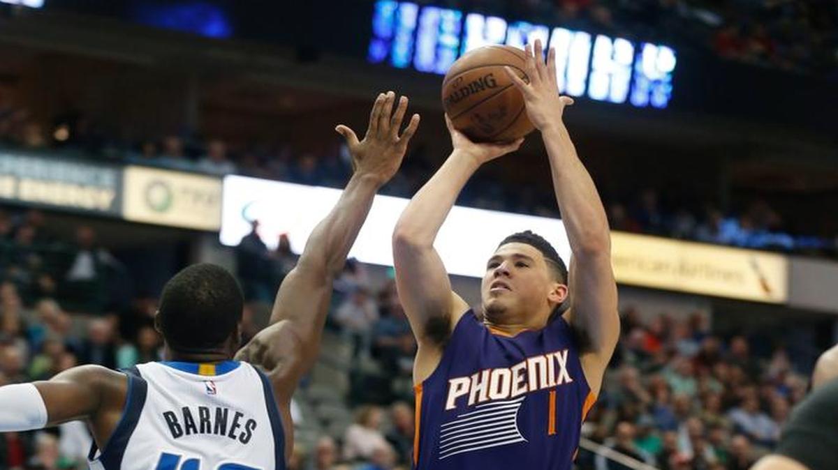 Phoenix Suns guard Devin Booker (1) shoots over Dallas Mavericks forward Harrison Barnes (40) during the second half of an NBA basketball game in Dallas, Saturday, March 11, 2017.