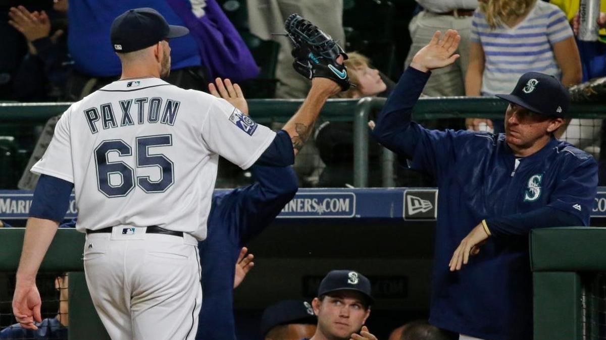 Seattle Mariners starting pitcher James Paxton (65) is greeted at the dugout after he got out of a jam to end the seventh inning of a baseball game against the Boston Red Sox, Monday, July 24, 2017, in Seattle.