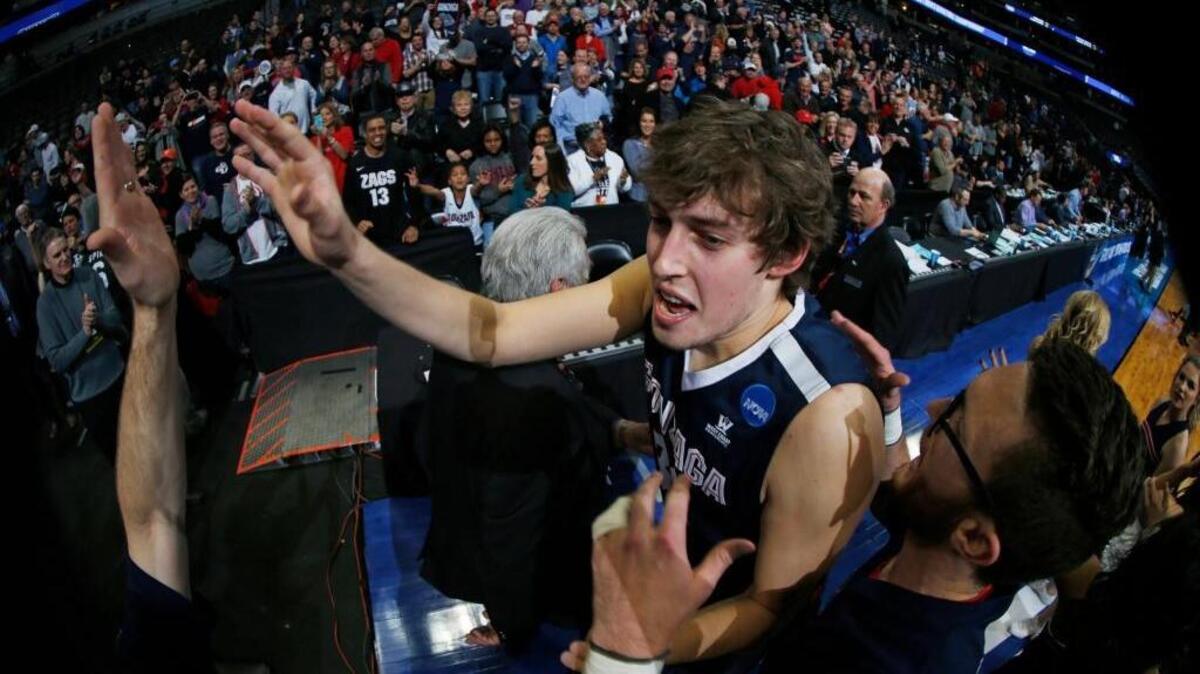 Gonzaga forward Kyle Wiltjer is congratulated as he leaves the court after Gonzaga defeated Utah 82-59 Saturday, March 19, 2016, in the second round of the NCAA men's college basketball tournament in Denver.