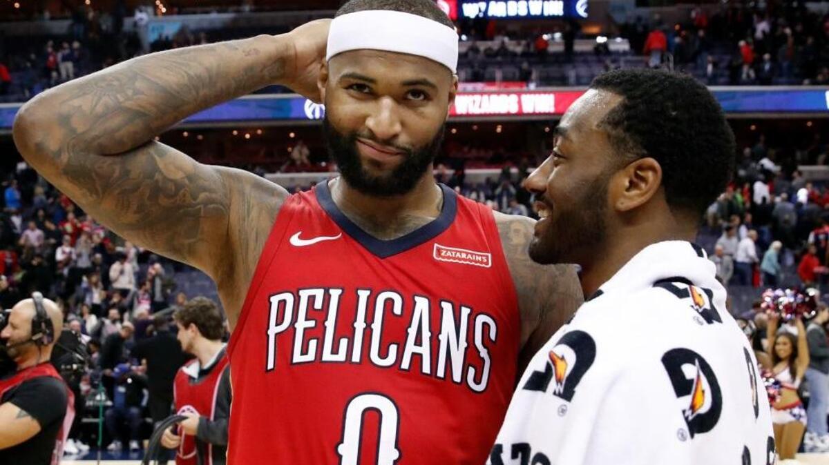 New Orleans Pelicans center DeMarcus Cousins, left, reacts as he talks with Washington Wizards guard John Wall after an NBA basketball game Tuesday, Dec. 19, 2017, in Washington. The Wizards won 116-106.