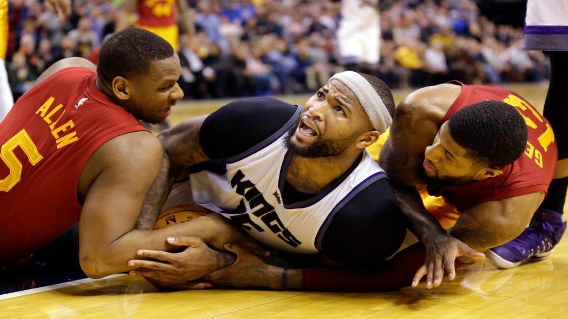 Sacramento Kings forward DeMarcus Cousins called time out Friday during a scramble for a loose ball with Indiana Pacers forward Lavoy Allen, left, and forward Paul George during overtime. The Pacers defeated the Kings, 115-111.