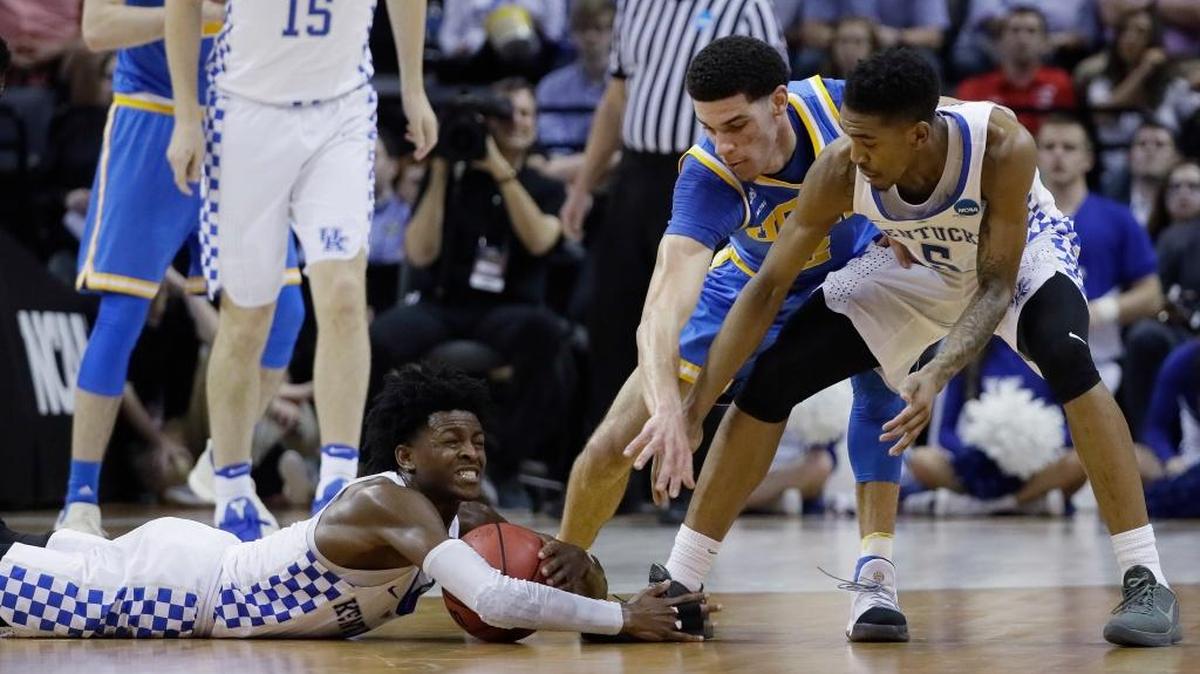 Kentucky guard De'Aaron Fox grabs the ball as UCLA guard Lonzo Ball and Kentucky guard Malik Monk look on in the second half of an NCAA college basketball tournament South Regional semifinal game Friday, March 24, 2017, in Memphis, Tenn.