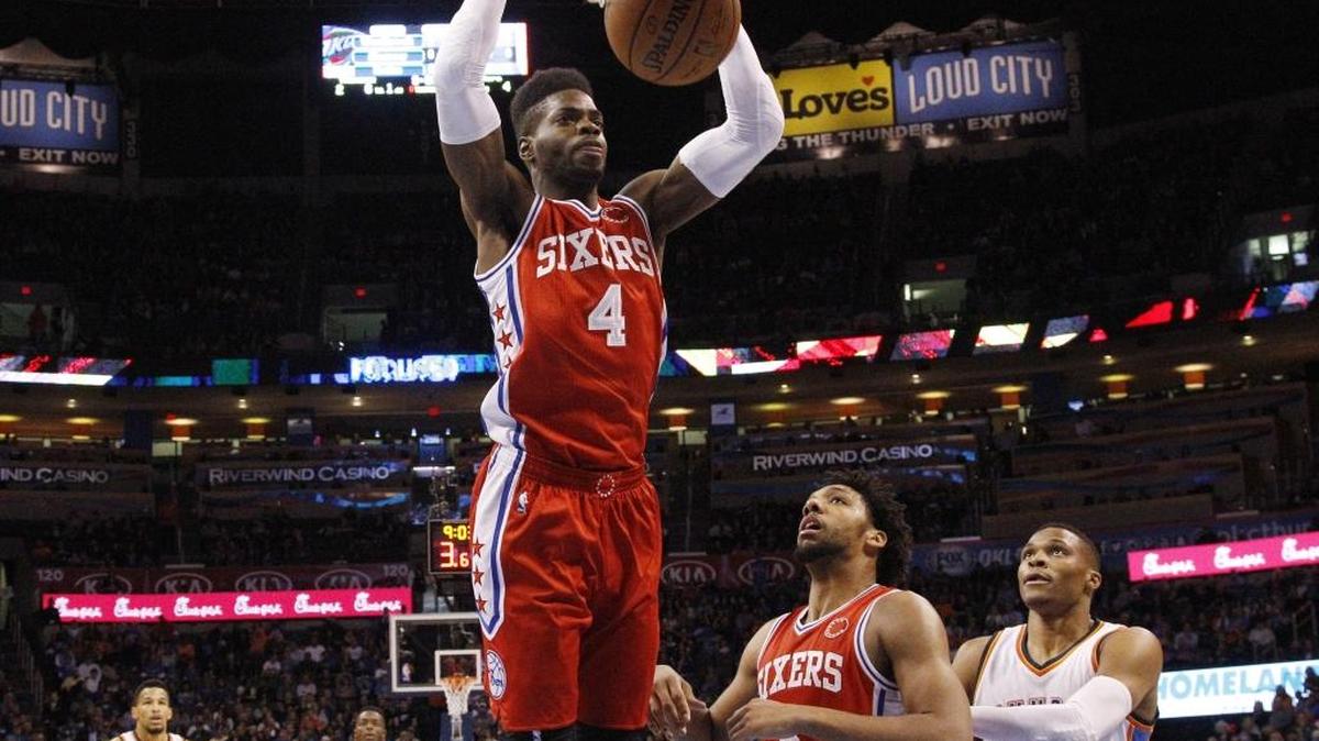 Philadelphia 76ers forward Nerlens Noel dunked in front of teammate Jahlil Okafor (8) and Oklahoma City Thunder guard Russell Westbrook (0) in Oklahoma City on Friday, Nov. 13, 2015.