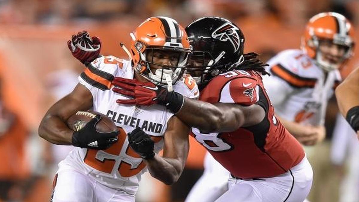 Cleveland Browns running back Raheem Mostert (25) ran the ball against Atlanta Falcons defensive tackle Cory Johnson, center right, in the second half of an NFL preseason football game on Thursday, Aug. 18, 2016, in Cleveland.