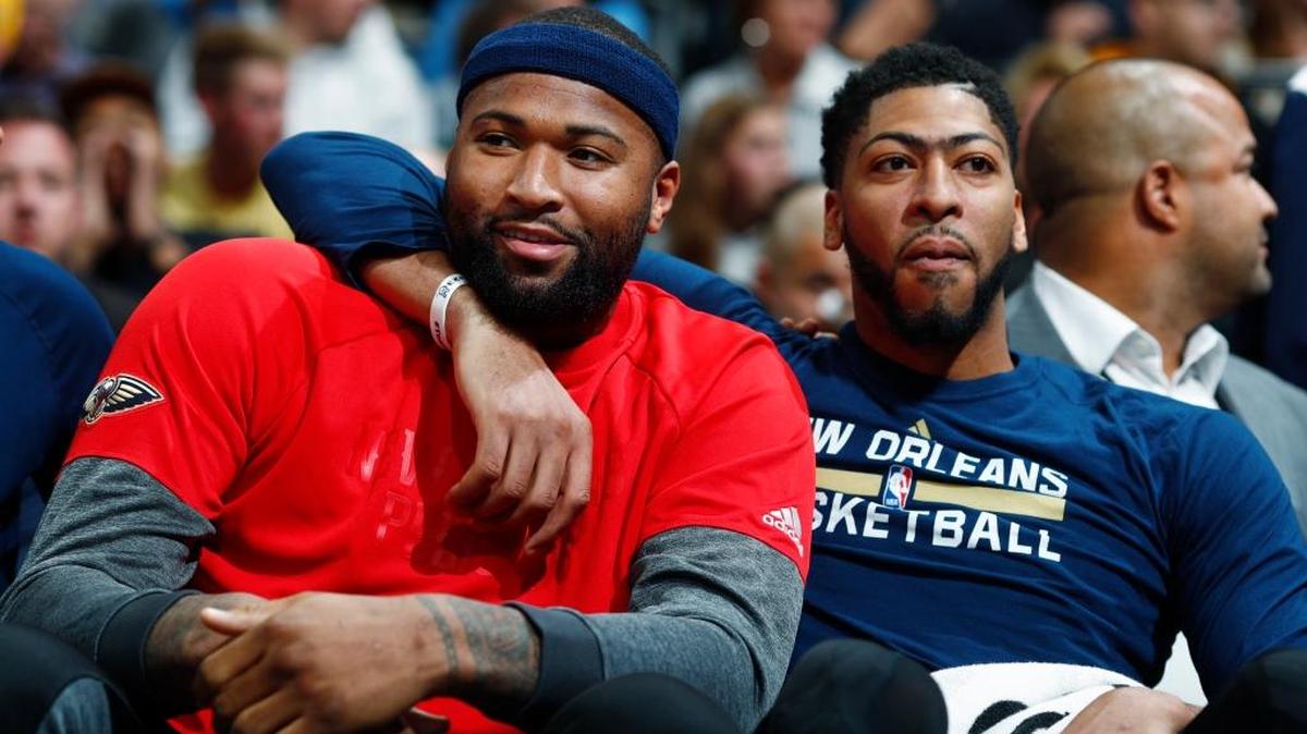 New Orleans Pelicans forwards DeMarcus Cousins, left, and Anthony Davis joke with each other as they sit on the bench and watch the second half of the team's NBA basketball game against the Denver Nuggets in Denver last April.