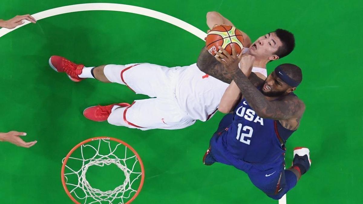 China’s Zou Yuchen (14) and the United States’ DeMarcus Cousins (12) fought for a rebound during a men’s basketball game at the 2016 Summer Olympics in Rio de Janeiro, Brazil on Saturday, Aug. 6, 2016.