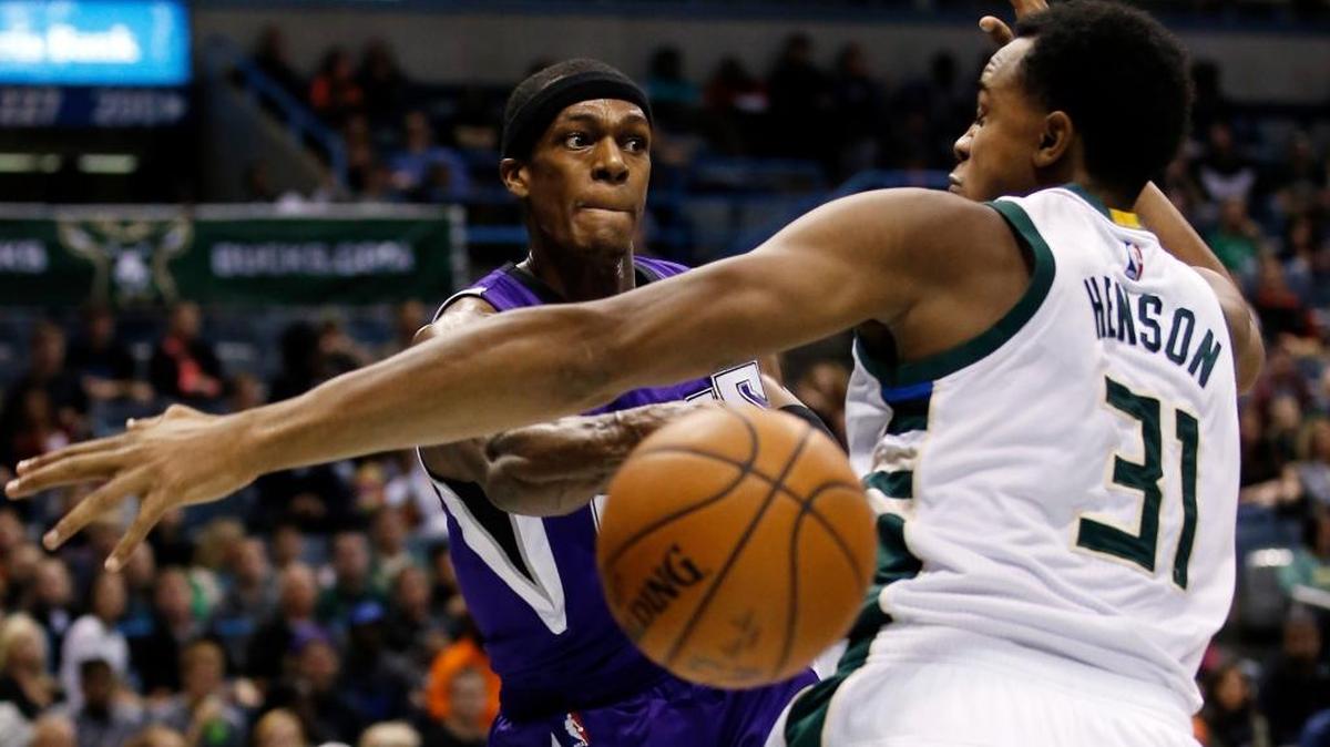 The Sacramento Kings’ Rajon Rondo passed around the Milwaukee Bucks’ John Henson during the first half on Nov. 25, 2015, in Milwaukee.
