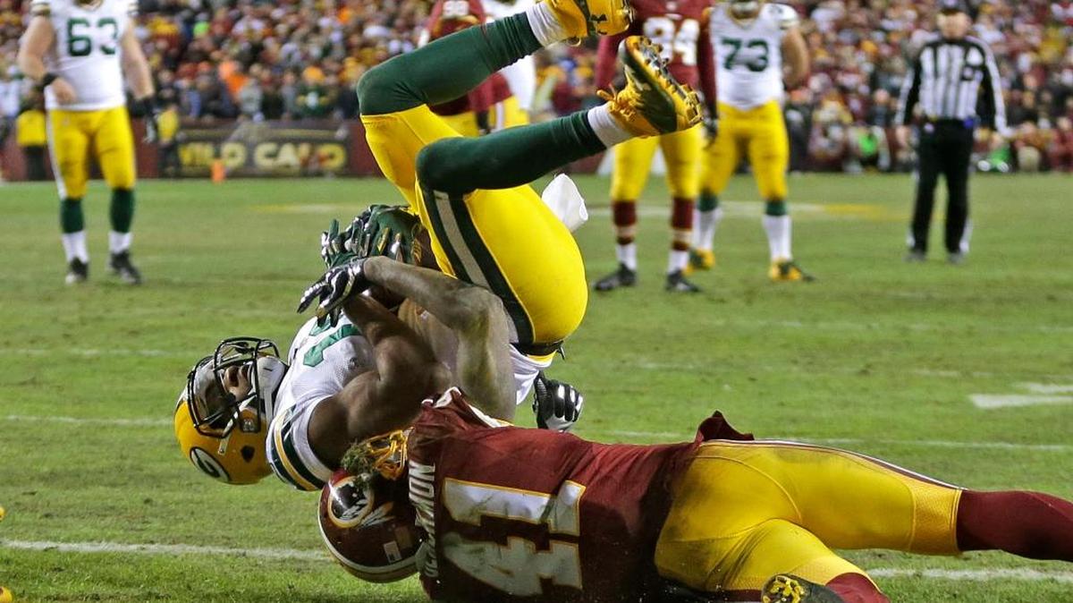 Green Bay Packers wide receiver Randall Cobb (18) hauled in a touchdown pass while being pulled down in the end zone by Washington Redskins cornerback Will Blackmon (41) during the second quarter on Sunday, Jan. 10, 2016, at FedEx Field in Landover, Md.