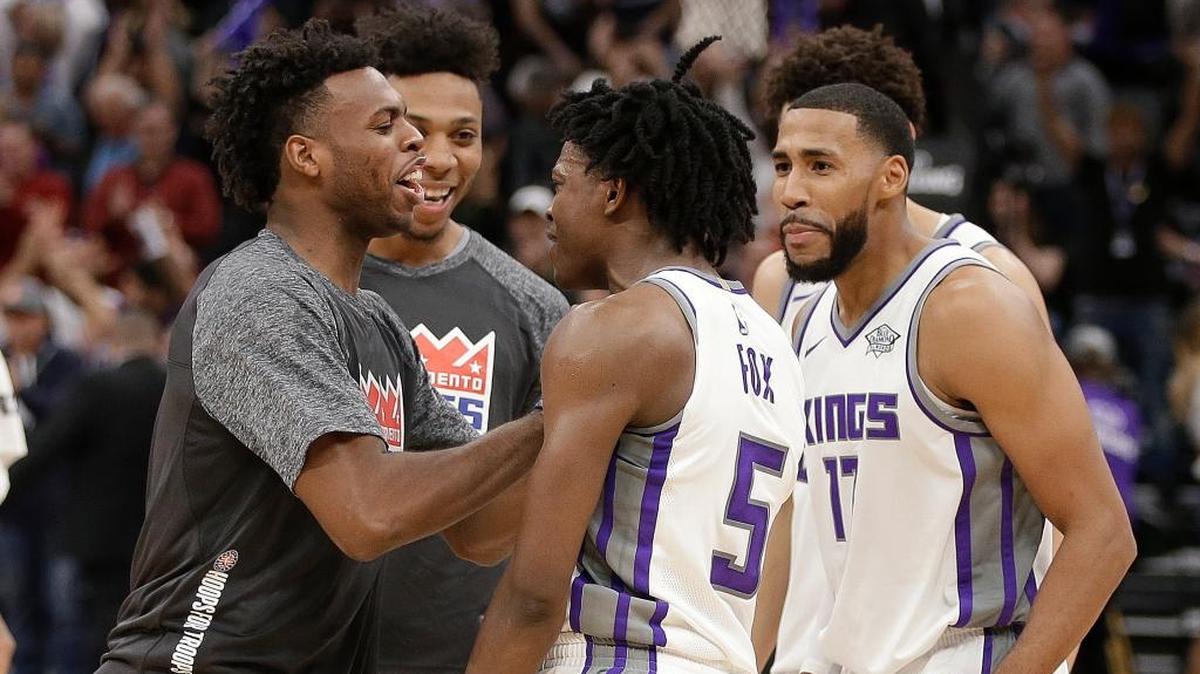 Sacramento Kings guard De’Aaron Fox, center, is greeted by teammates Buddy Hield, left, Malachi Richardson, second from left, and Garrett Temple, right, after the Kings defeated the Philadelphia 76ers 109-108 in an an NBA basketball game Thursday, Nov. 9, 2017, in Sacramento, Calif. Fox made what proved to be the game-winning shot for the Kings.