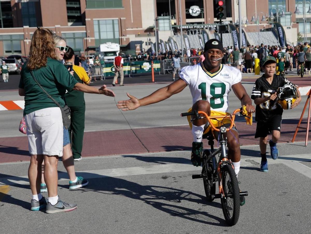 The Green Bay Packers' Randall Cobb rides a bike to NFL football training camp Thursday, July 27, 2017, in Green Bay, Wis.