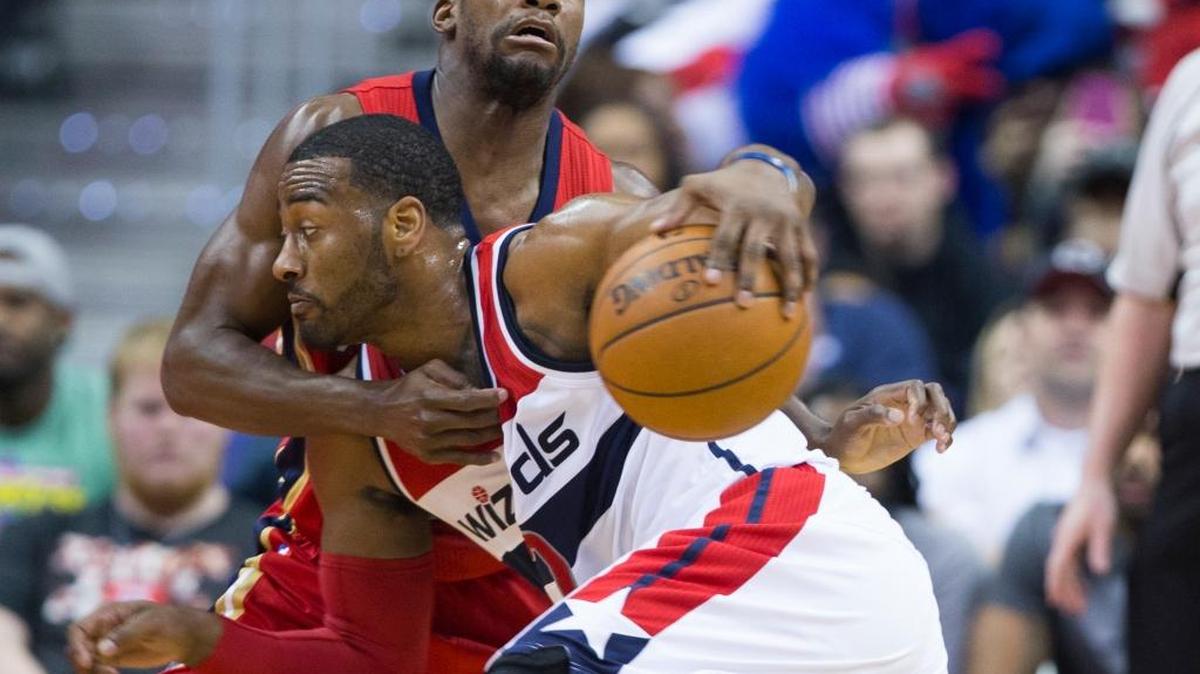 Pelicans guard Toney Douglas, left, tried to defend against the Wizards’ John Wall during the first half Tuesday in Washington.