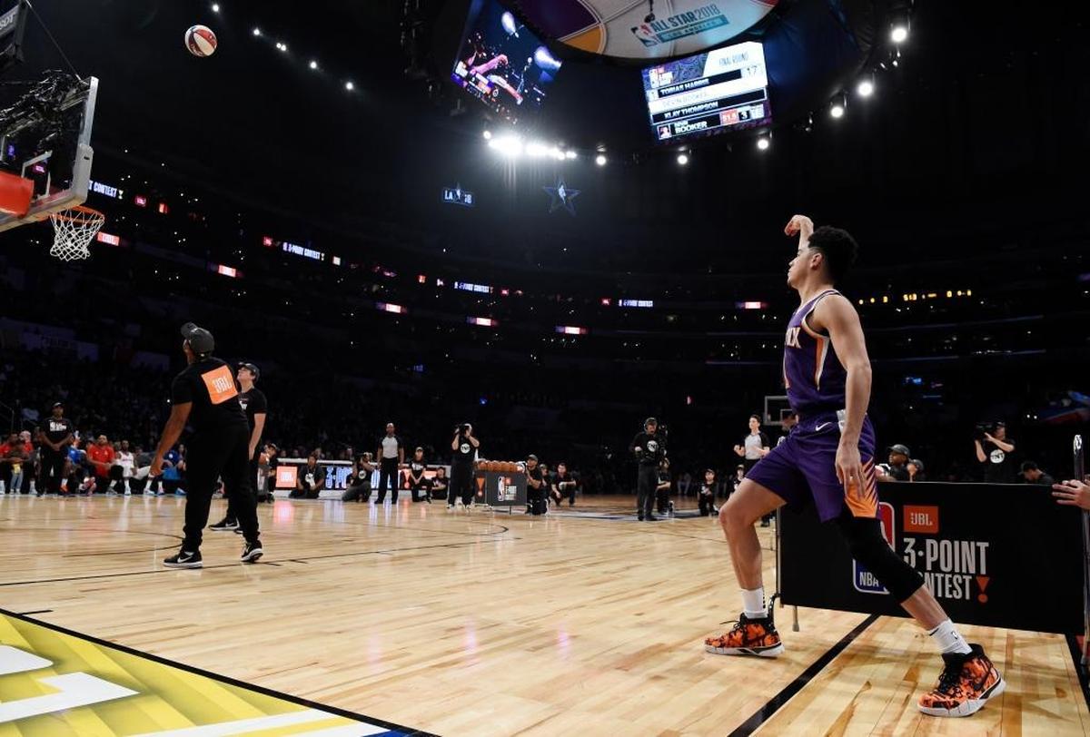 Phoenix Suns' Devin Booker watches a shot during the NBA basketball All-Star weekend 3-Point contest Saturday, Feb. 17, 2018, in Los Angeles. Booker won the event.