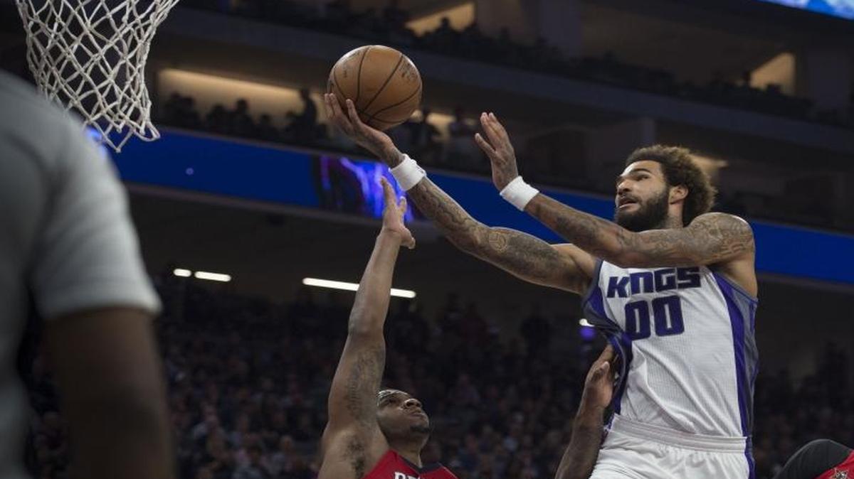 Sacramento Kings center Willie Cauley-Stein (00) scores a basket against New Orleans Pelicans forward Terrence Jones (9) and New Orleans Pelicans forward Anthony Davis (23) during their game at the Golden 1 Center on Tuesday, November 8, 2016 in Sacramento.