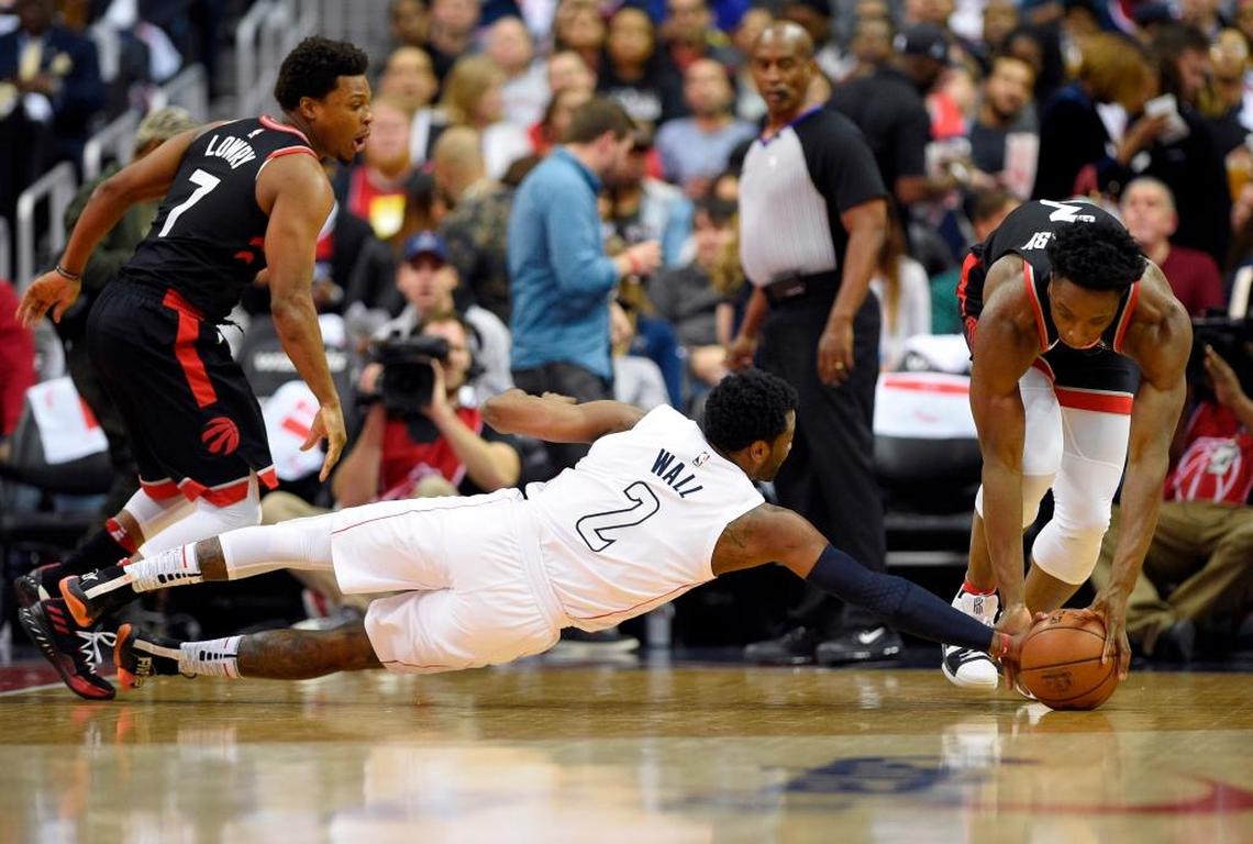 Wizards guard John Wall vied for the ball with Raptors forward OG Anunoby, right, and guard Kyle Lowry (7) during the first half of Game 4 on Sunday.