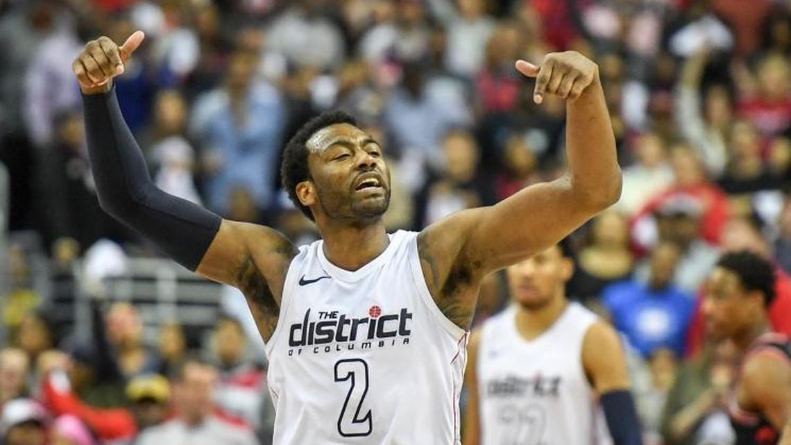 Wizards guard John Wall celebrated at the end of their win over the Raptors at Capital One Arena on Sunday.