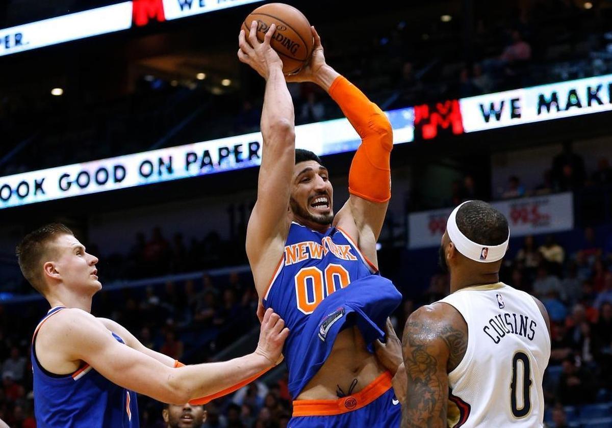 New York Knicks center Enes Kanter (00) rebounds the ball over New Orleans Pelicans center DeMarcus Cousins (0) during the first half of an NBA basketball game in New Orleans, Saturday, Dec. 30, 2017.