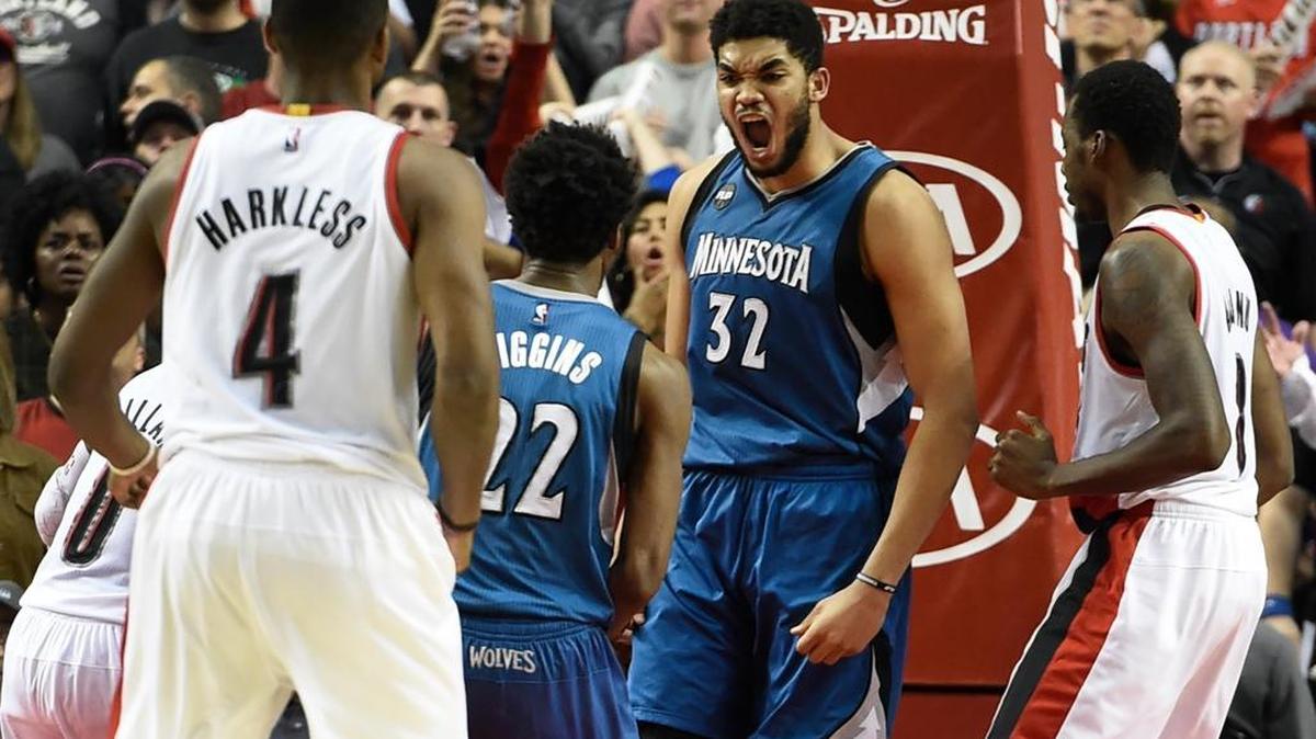 Minnesota Timberwolves center Karl-Anthony Towns (32) celebrates with guard Andrew Wiggins (22) after hitting the game-winning shot during the fourth quarter of an NBA basketball game in Portland, Ore., Saturday, April 9, 2016. The Timberwolves won 106-105.