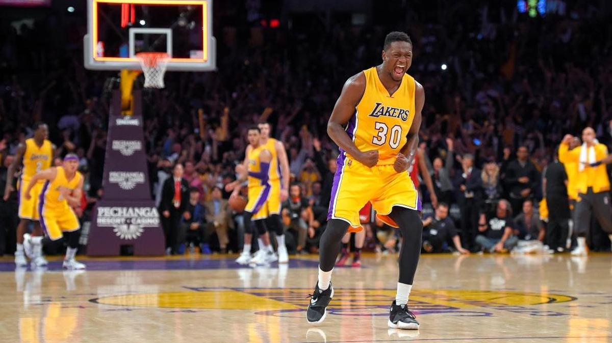 Los Angeles Lakers forward Julius Randle, front, celebrates as the Lakers defeat the Miami Heat in overtime in an NBA basketball game, Wednesday, March 30, 2016, in Los Angeles. The Lakers won 102-100.