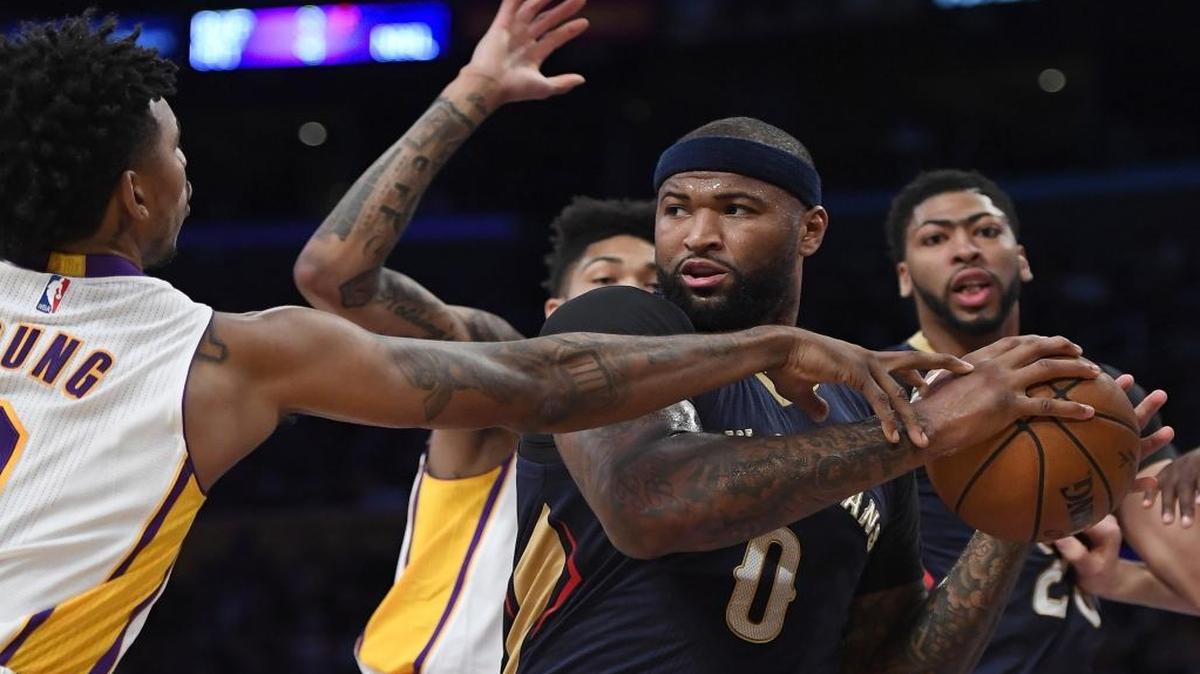Los Angeles Lakers guard Nick Young, left, reaches in on New Orleans Pelicans forward DeMarcus Cousins during the first half of an NBA basketball game Sunday, March 5, 2017, in Los Angeles.