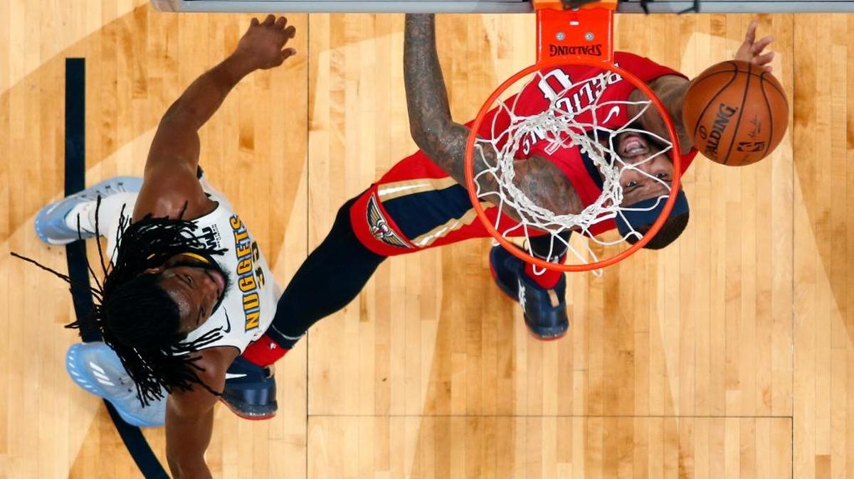 New Orleans Pelicans center DeMarcus Cousins (0) goes to the basket against Denver Nuggets forward Kenneth Faried, left, in the first half of an NBA basketball game in New Orleans, Wednesday, Dec. 6, 2017.