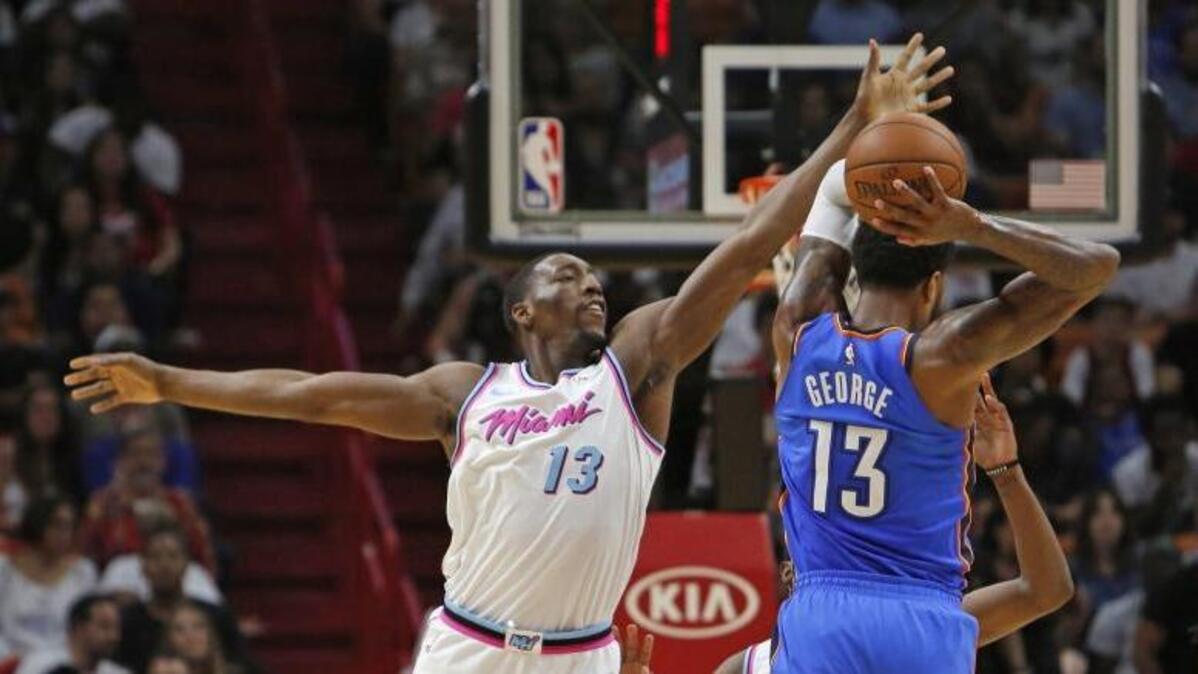 Thunder forward Paul George attempted to pass against Heat forward Bam Adebayo during the second quarter on April 9.