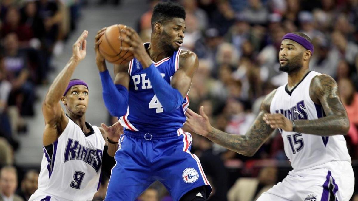 Philadelphia 76ers center Nerlens Noel (4) battles for position against Sacramento Kings defenders Rajon Rondo (9) and DeMarcus Cousins (15) during the second half of an NBA basketball game in Sacramento, Calif., Wednesday, Dec. 30, 2015. The 76ers won 110-105.
