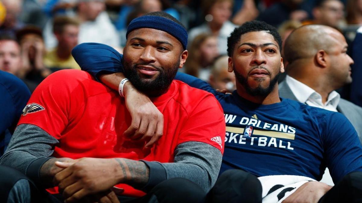 New Orleans Pelicans forwards DeMarcus Cousins, left, and Anthony Davis joked with each other as they sat on the bench and watched part of the second half of the team's game against the Denver Nuggets on April 7, 2017.