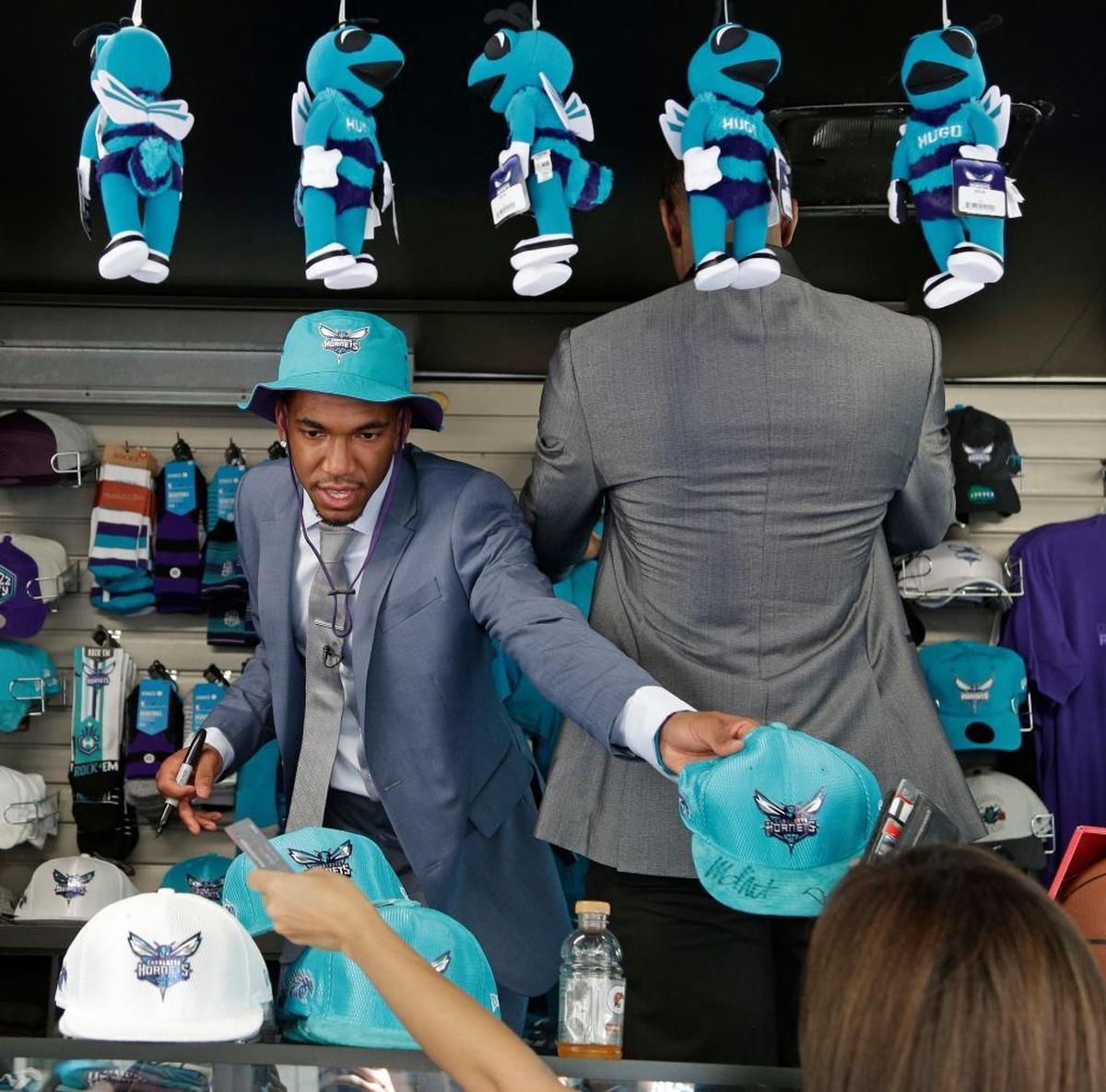 Charlotte Hornets NBA basketball draft pick Malik Monk hands out autographed merchandise to fans at a downtown market in Charlotte, N.C., Friday, June 23, 2017.