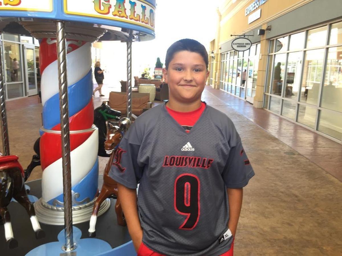 Jimmy Wynn, 13, said he was wearing Louisville shirt Saturday because his girlfriend is Cardinals fan, but he stuffed the T-shirt in a bag his mother was carrying before he met former Kentucky star Malik Monk.