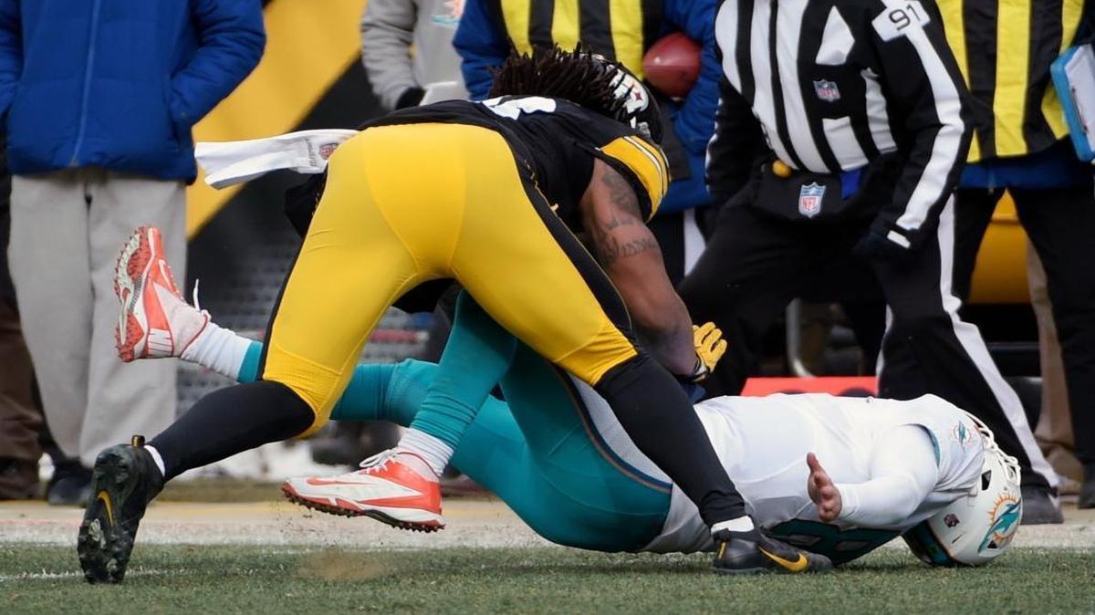Pittsburgh Steelers outside linebacker Bud Dupree, top, hits Miami Dolphins quarterback Matt Moore (8) during the first half of an AFC wild-card NFL football game in Pittsburgh, Sunday, Jan. 8, 2017. Moore was able to return to the game.