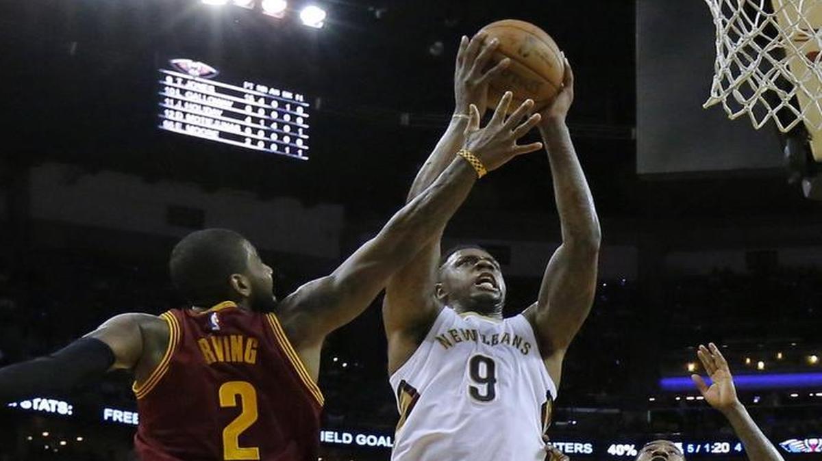 Pelicans forward Terrence Jones (9) drove to the basket against Cavaliers guard Kyrie Irving (2) and guard Iman Shumpert (4) during the first half Monday in New Orleans.