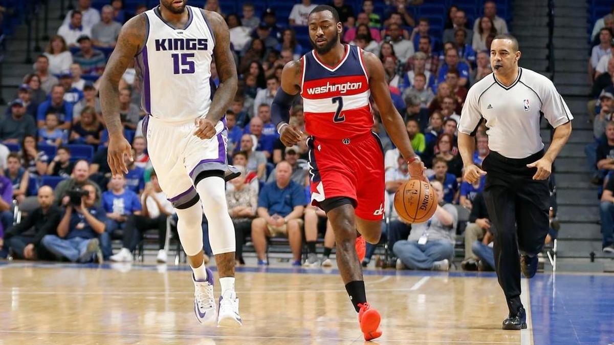 Washington Wizards guard John Wall (2) brought eh ball up court as Sacramento Kings center DeMarcus Cousins (15) trailed in the 1st quarter as the Washington Wizards played the Sacramento Kings in a preseason game at Rupp Arena in Lexington, Ky., Saturday, October 15, 2016. The game featured the return to Lexington of former UK stars DeMarcus Cousins, Willie Cauley-Stein and Skal Labissiere of the Sacramento Kings along with John Wall of the Washington Wizards.