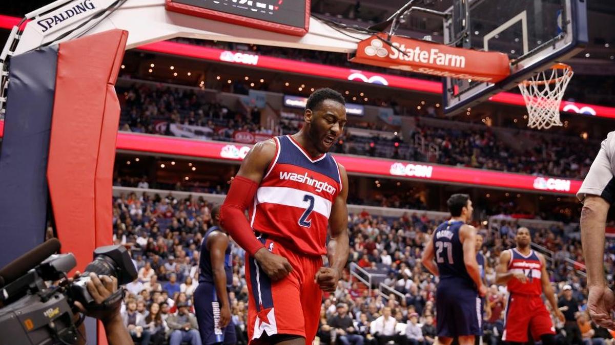 Washington Wizards guard John Wall (2) reacts after a shot in the second half of an NBA basketball game against the Dallas Mavericks, Sunday, Dec. 6, 2015, in Washington. The Mavericks won 116-104.