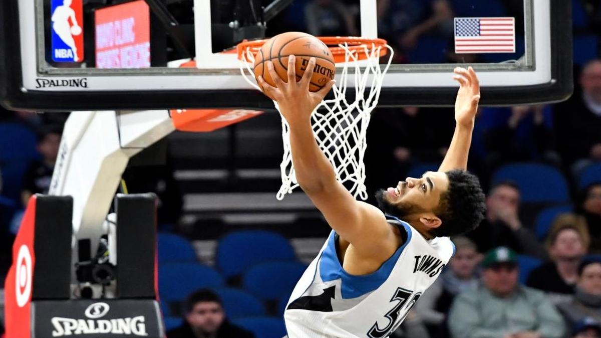 FILE - In this Feb. 4, 2017, file photo, Minnesota Timberwolves' Karl-Anthony Towns grabs a rebound against the Memphis Grizzlies during the second half of an NBA basketball game in Minneapolis. If the Timberwolves are going to defy the odds and make the playoffs, they will do so on the back of Towns. The second-year center is on a torrid run, solidifying himself as a force during Minnesota's frantic playoff push.