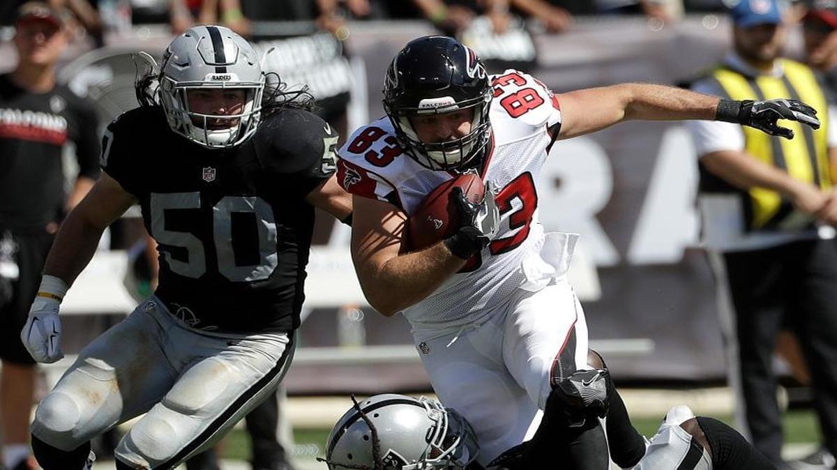Atlanta Falcons tight end Jacob Tamme (83) runs against Oakland Raiders middle linebacker Ben Heeney (50) and free safety Reggie Nelson during the first half of an NFL football game in Oakland, Calif., Sunday, Sept. 18, 2016.