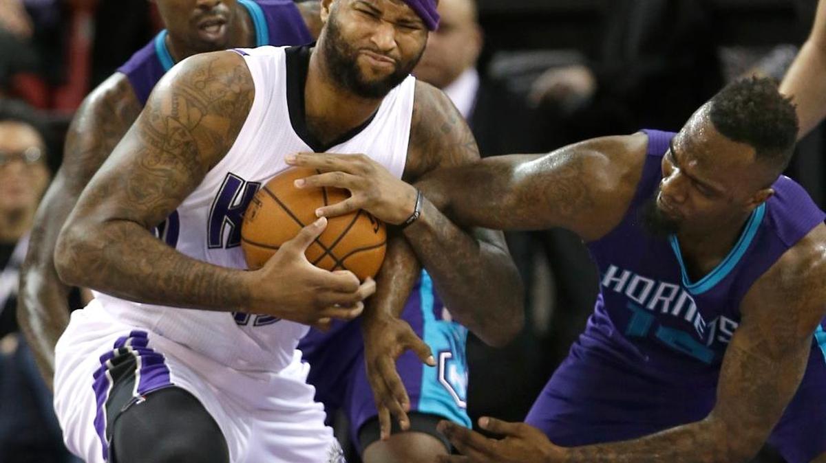 Sacramento Kings center DeMarcus Cousins, left, pulled the ball away from Charlotte Hornets forward P.J. Hairston during the first quarter on Monday, Jan. 25, 2016, in Sacramento, Calif.