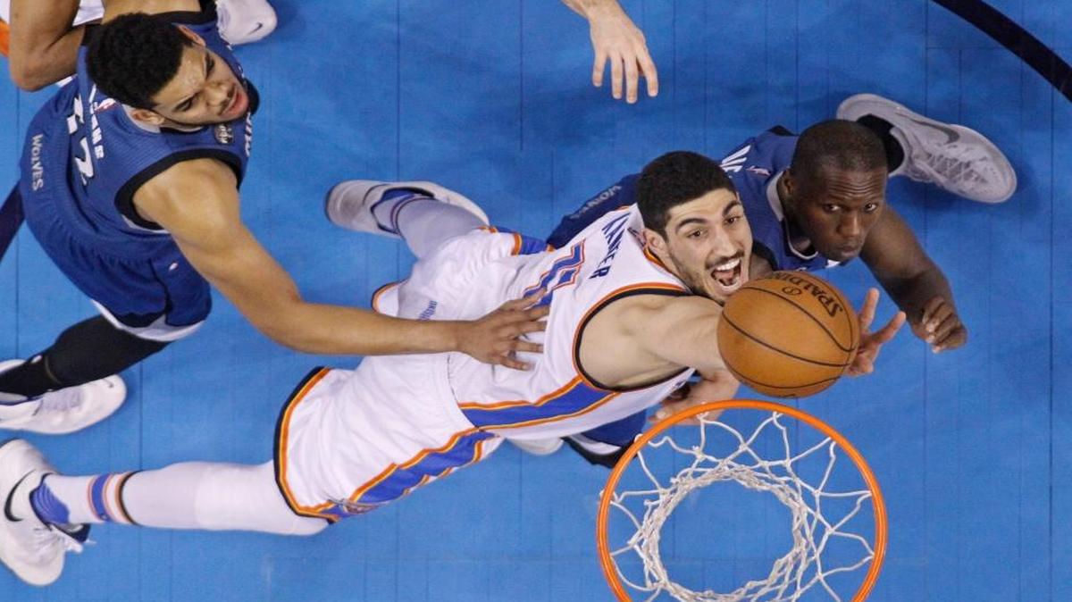 The Thunder’s Enes Kanter, center, reached for a rebound between the Timberwolves’s Karl-Anthony Towns, left, and Gorgui Dieng during the second quarter in Oklahoma City on Friday, March 11, 2016.