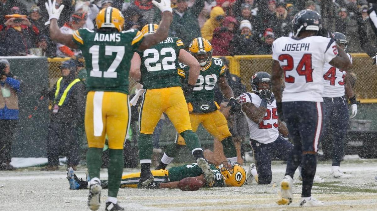 The Green Bay Packers' Randall Cobb did a snow angel after catching a touchdown pass during the first half against the Houston Texans.