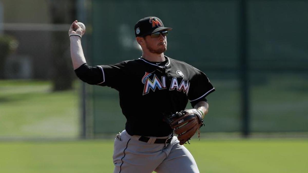 Miami Marlins third baseman J.T. Riddle throws during a spring training baseball workout Friday, Feb. 17, 2017, in Jupiter, Fla.