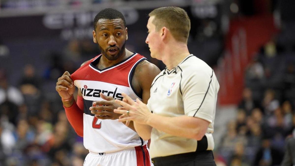 Washington Wizards guard John Wall (2) talks to referee Nick Buchert, right, during the first half of an NBA basketball game against the Orlando Magic, Tuesday, Dec. 6, 2016, in Washington.