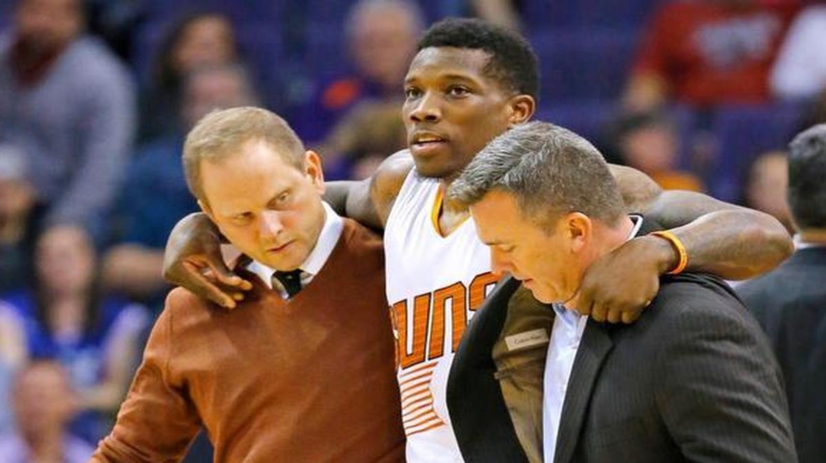 Suns guard Eric Bledsoe, center, was helped off the court after being injured in the first half against the 76ers on Saturday, Dec. 26, 2015, in Phoenix.