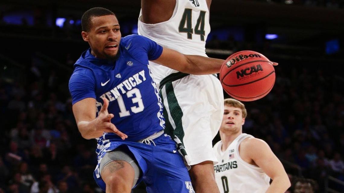 Kentucky guard Isaiah Briscoe (13) passed around Michigan State forward Nick Ward (44) on a drive on Nov. 15, 2016, in New York.