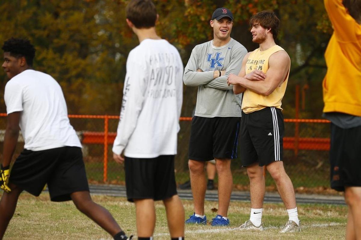 Former University of Kentucky quarterback Patrick Towles, left, laughs with Paris High School tight end Will Cox during football practice at Blanton Collier Stadium in Paris, Ky., Thursday, Nov. 2, 2017.