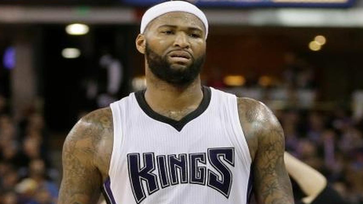 The Kings’ DeMarcus Cousins passed Coach George Karl, right, as he walked to the bench during the second half against the Utah Jazz on March 13 in Sacramento, Calif. Cousins served a one game suspension, imposed by the Kings for “conduct detrimental to the team” after remarks he made to Karl during their game against the Cleveland Cavaliers.